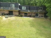 Townhome exterior with a large backyard and a quaint patio area for outdoor enjoyment at 187 Peyton Sw Pl, Atlanta, GA 30311