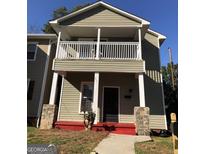 Charming two-story home featuring a cozy balcony and inviting front entrance at 821 Beckwith Sw St, Atlanta, GA 30314