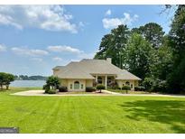 Expansive single-story home with beautiful lawn and lake views at 2643 Edgewater Ct, Jonesboro, GA 30236