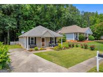 Charming single-story home with a well-manicured lawn and inviting front porch at 136 Glynn Addy Dr, Stockbridge, GA 30281