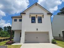 Two-story white brick home with modern farmhouse design and attached garage at 43 Avian Way # 3B, Auburn, GA 30011