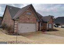 Traditional brick home with attached garage and well-maintained lawn at 3349 Alhambra Cir, Hampton, GA 30228