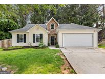 Charming single-story home with a two-car garage and manicured front lawn at 11765 Fairway Overlook, Fayetteville, GA 30215