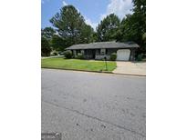 Charming single-Gathering home featuring a garage, well-kept lawn, and traditional design at 5639 Mallard Trl, Lithonia, GA 30058
