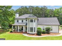 Charming two-story home with a covered front porch, detailed trim, and a well-maintained lawn at 140 Laurel Lake Rd, Tyrone, GA 30290