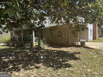View of the home's front exterior, showing a swing and breeze block wall at 2534 Highway 155 N, Mcdonough, GA 30252