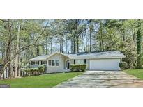 Charming ranch-style home featuring a manicured front yard and attached two-car garage at 530 Valley Woods Se Cir, Conyers, GA 30094