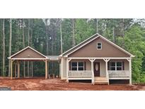 Charming single-story home with a welcoming front porch and convenient carport at 55 Etheridge Rd, Temple, GA 30179