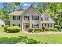Charming two-story home featuring a well-manicured lawn and classic shutters at 15 Skipton Ct, Sharpsburg, GA 30277
