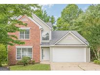 Charming two-story home featuring brick accents, a two-car garage, and a well-maintained front lawn at 2576 Abbotts Glen Nw Dr, Acworth, GA 30101