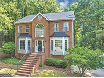 Charming two-story brick home with beautiful windows, black shutters and a landscaped front yard at 1625 Clark Lake Nw, Acworth, GA 30102