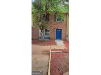 Charming brick townhouse with a blue door and beautiful yard at 5579 Marbut Rd, Lithonia, GA 30058