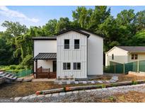 Charming two-story home featuring white siding, black trim, and a cozy front porch at 2328 Lakewood Ave Sw, Atlanta, GA 30315