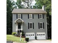 Charming two-story home with a gray exterior, black shutters, and a well-manicured lawn at 1886 Hamby Place Nw Dr, Acworth, GA 30102