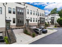 Beautiful townhomes showcase brick and painted exteriors, private garages, and inviting staircases at 2118 Iverson Se Dr, Smyrna, GA 30080