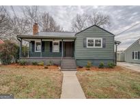 Charming home with a covered front porch, metal roof, and neatly landscaped front yard, offering great curb appeal at 4131 Carroll Sw St, Covington, GA 30014