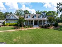 Stunning home with a lush green lawn and charming front porch perfect for relaxing at 3170 Monroe Jersey Rd, Covington, GA 30014
