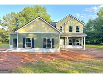 Charming two-story home featuring a covered porch and stylish exterior with black shutters at 88 Maddox Drive, Mcdonough, GA 30253