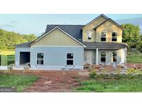 New two-story home with gray siding, awaiting finishing touches and landscaping in a serene setting at 58 Maddox Drive, Mcdonough, GA 30252