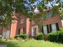 Charming brick two-story home with black shutters, front lawn, and front entrance at 6570 Laurens Way, Stone Mountain, GA 30087