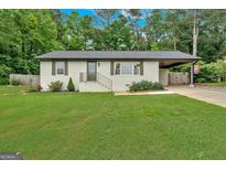 Charming, renovated brick ranch on a lush lot with a carport, offering curb appeal and ample space at 30 Mary Ella Dr, Carrollton, GA 30116
