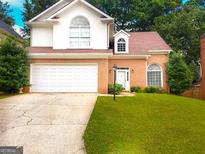 Charming two-story home with a brick facade, two-car garage, and well-maintained front yard at 3332 Glenrose Trl, Chamblee, GA 30341
