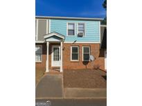 Charming townhome featuring a brick facade, blue siding, and a welcoming front entrance at 796 Glynn Oaks Dr, Clarkston, GA 30021