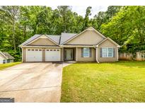 Charming single-Gathering home boasts a two-car garage and well-manicured lawn surrounded by mature trees at 345 Morning Star Dr, Temple, GA 30179