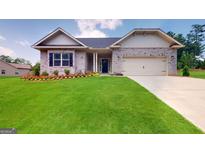Charming single-story home with manicured lawn and beautiful flower beds at 263 Eason St, Bowdon, GA 30108
