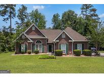 Charming brick home with green shutters and a well-manicured lawn at 2928 Mandy Ct, Jonesboro, GA 30236