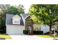 Charming two-story home with brick facade, attached garage, and well-maintained landscaping at 149 Titan Rd, Stockbridge, GA 30281