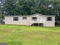 Charming single-story home featuring a well-maintained lawn and cozy front porch, perfect for relaxed living at 368 Hemlock Ln, Locust Grove, GA 30248