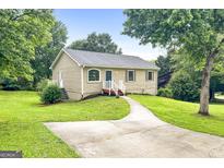 Charming single-story home featuring a well-manicured lawn and inviting front walkway at 1432 Almand Creek Drive Sw, Conyers, GA 30094