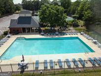 Community pool and lounge area with umbrellas and playground, adjacent to the clubhouse and tennis courts at 330 Bay Grove Rd, Loganville, GA 30052
