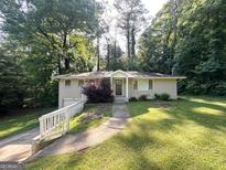 Charming single-story home with well-maintained lawn and mature trees at 570 Kenridge Cir, Stone Mountain, GA 30083