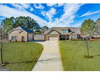 Beautiful home with lush landscaping and a detached garage, offering plenty of space and curb appeal at 125 Kayla Ct, Locust Grove, GA 30248