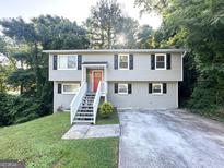 Inviting exterior of home with gray siding, red door, and landscaped front yard at 2784 Rockdale Dr, Decatur, GA 30034