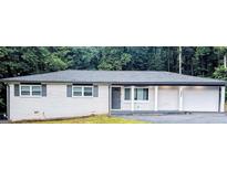 Charming single-story home with freshly painted white brick exterior and attached carport at 5425 Herndon Blvd, Morrow, GA 30260