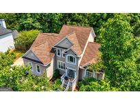 Stunning traditional-style home with a well-maintained brown roof and lush green landscaping at 306 Sandalin Ln, Peachtree City, GA 30269