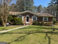 Charming single-story brick home featuring a well-maintained front yard and classic architectural details at 420 Dot Dr, South Fulton, GA 30349