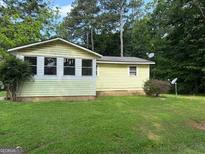 Charming single-story home featuring a sunny exterior, spacious yard, and mature trees at 22 Shell Rd, Carrollton, GA 30116