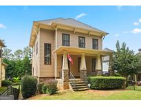 Charming two-story home featuring a welcoming front porch with stone accents and well-manicured landscaping at 3451 Fairway Dr, College Park, GA 30337