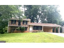 Two-story brick home with a covered carport and a well-maintained front lawn at 4196 Lehigh Blvd, Decatur, GA 30034