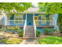 Charming blue home with a welcoming front porch, white railings, and landscaped yard at 638 Mcgruder Ne St, Atlanta, GA 30312