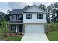 Charming two-story home with a two-car garage and a well-manicured front yard at 116 Deer Xing, Temple, GA 30179