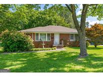 Charming brick home with well-maintained lawn, mature landscaping, and inviting curb appeal at 1070 Elaine Dr, Forest Park, GA 30297