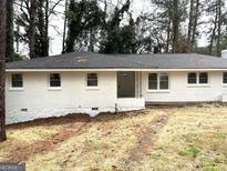 Charming single-story home featuring a freshly painted white brick exterior and a well-maintained lawn at 3994 E Hilda Cir, Decatur, GA 30032