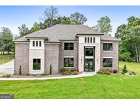 Gorgeous gray brick home with stone accents and a well-manicured front lawn, creating curb appeal at 3012 Flat Shoals Sw Rd, Conyers, GA 30094