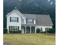 Charming two-story home with a well-manicured lawn and traditional architectural details at 4489 Northwind Dr, Ellenwood, GA 30294
