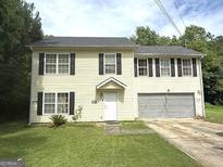 Charming two-story home with a well-maintained lawn and attached two-car garage at 2841 Heritage Ln, Morrow, GA 30260